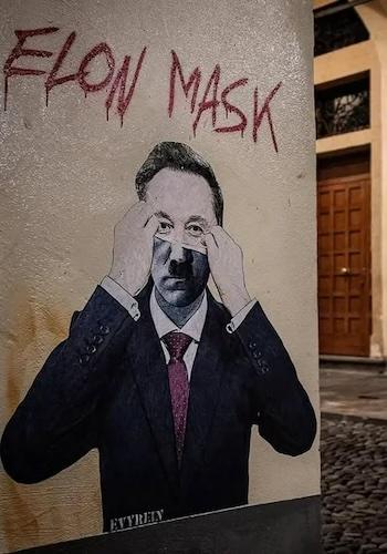A street art mural depicts a man in a suit and tie, hands raised to his eyes as if adjusting glasses or shielding them…