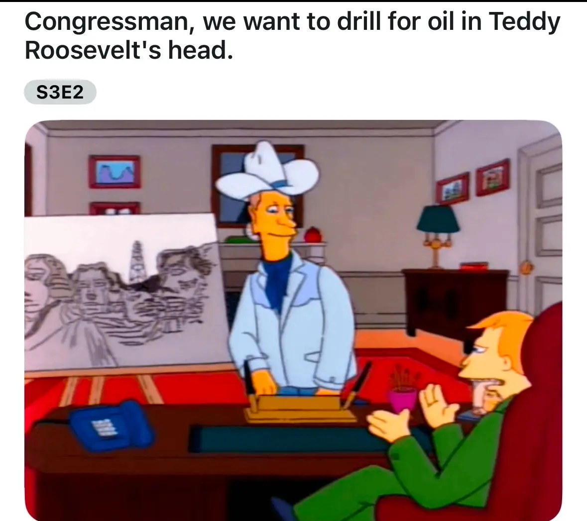 In a scene from The Simpsons, a man in a cowboy hat stands at a desk while another man sits in a chair. The standing man…