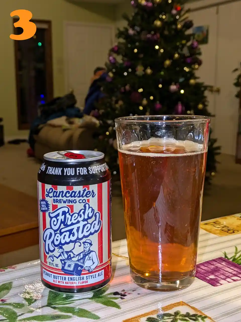 A can of Lancaster Brewing Co.'s 'Fresh Roasted' peanut butter English style ale sits next to a full glass of the beer on a…