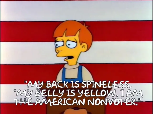 A still image of the animated character Bart Simpson, with his signature orange hair and blue overalls, standing in front of…