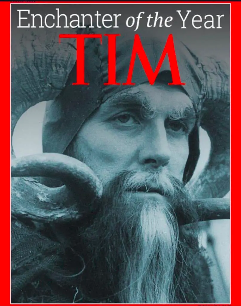 A black-and-white photo of a man with a long beard and horns, styled like a fantasy character, overlaid with the text…