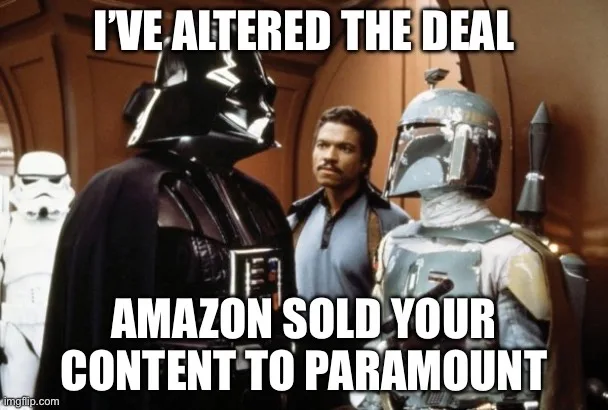 A still from Star Wars shows Darth Vader, Boba Fett, and a Stormtrooper with a man in a blue shirt standing between them…