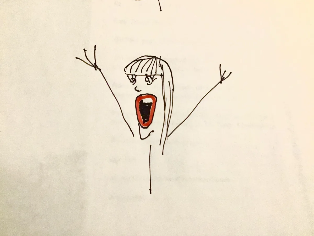 A simple black ink drawing on white paper shows a stick-figure-like person with long hair, wide eyes, and an open mouth…