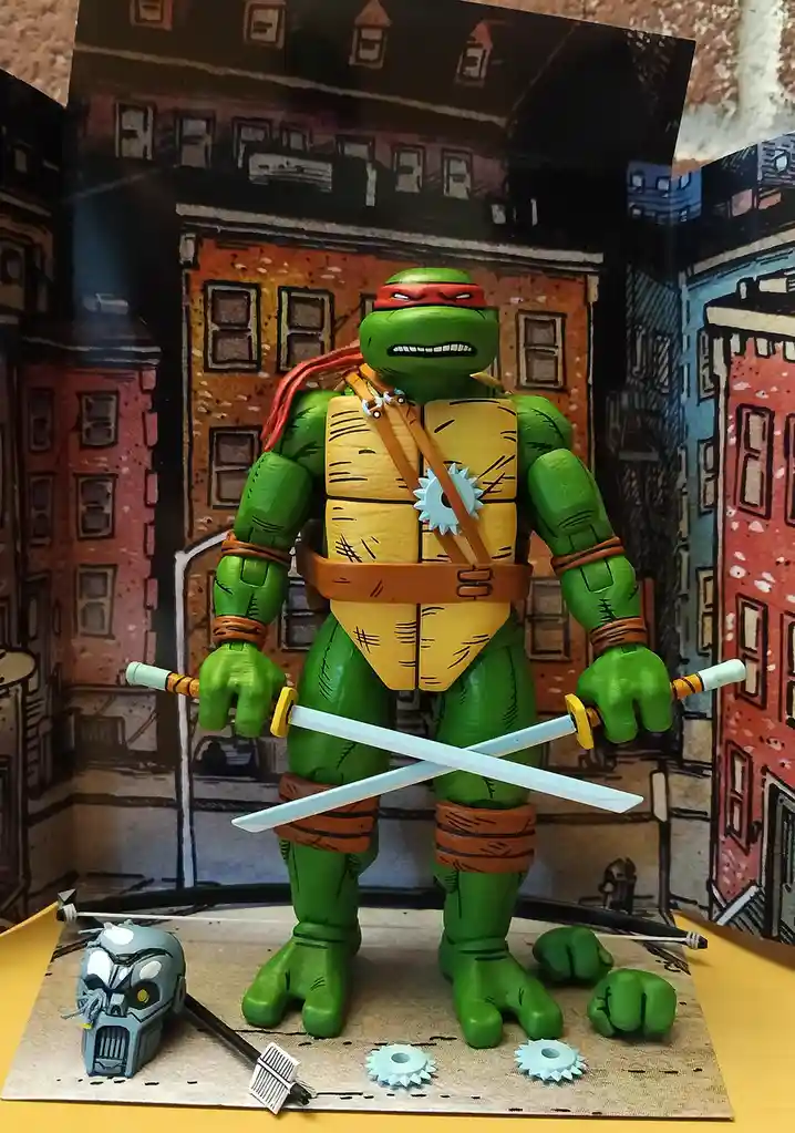 A green Teenage Mutant Ninja Turtle action figure, identifiable as Raphael by his red bandana, stands in a cityscape diorama…