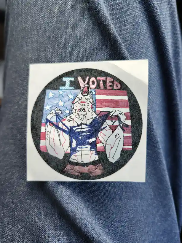 A hand-drawn sticker on a blue denim shirt shows a muscular, wolf-headed figure ripping open its shirt to reveal an American…