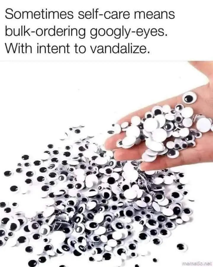 A hand is shown holding a large pile of googly eyes, with more scattered on a white background. The overlaid text reads…