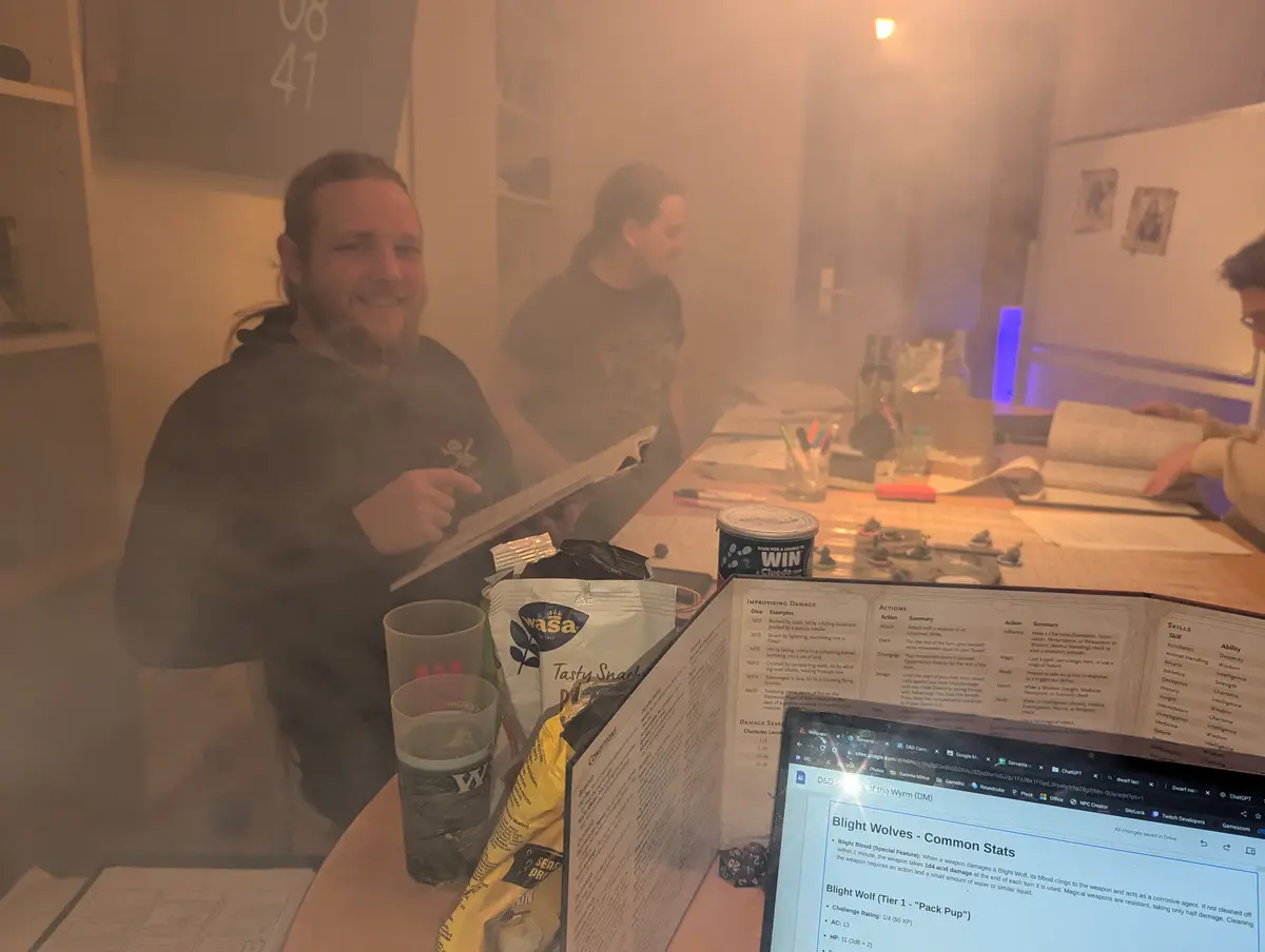 A group of people are gathered around a table covered in roleplaying game materials, including character sheets, dice…