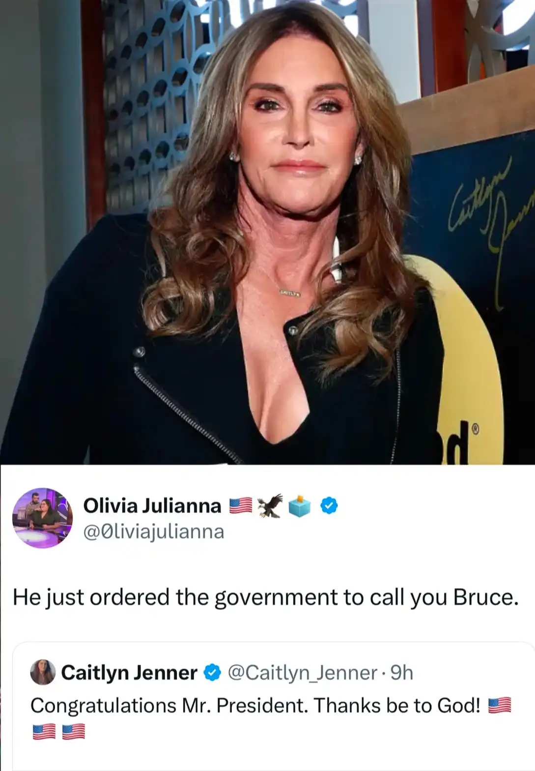 The image shows Caitlyn Jenner in a black jacket with a deep neckline, standing in front of a backdrop with her signature…