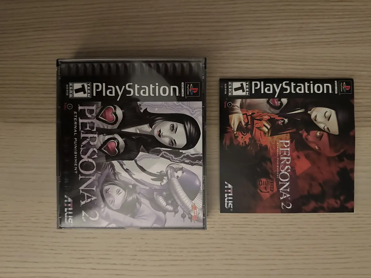 Two PlayStation game cases for 'Persona 2: Eternal Punishment' and 'Persona 2: Eternal Punishment' are shown side-by-side on…