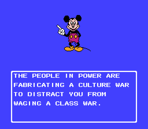 A pixelated image of Mickey Mouse pointing upward against a solid blue background. Below him is a white-bordered text box…