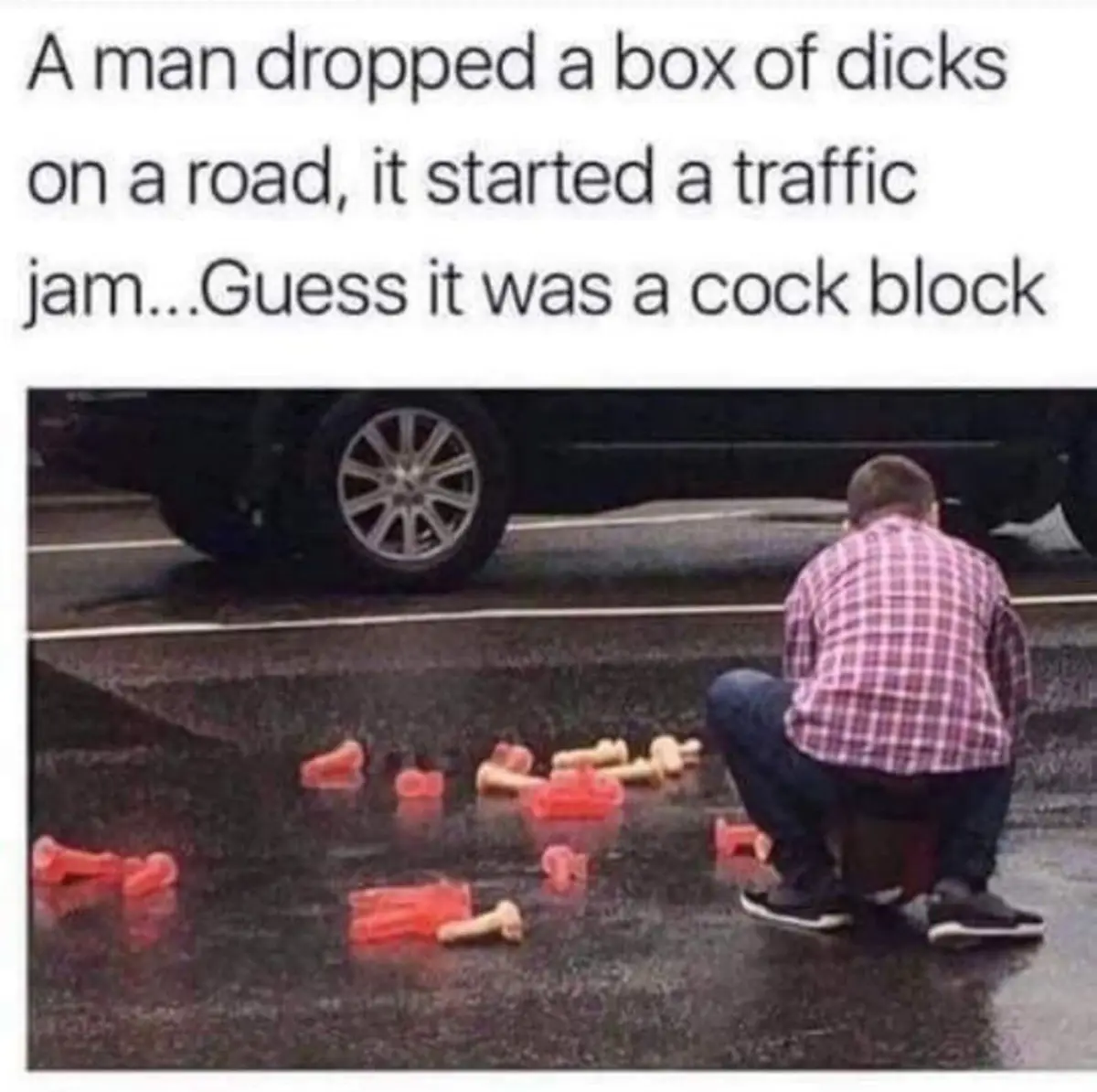A man in a plaid shirt is crouching on a wet road next to scattered red and beige plastic toy phalluses. A car is stopped…
