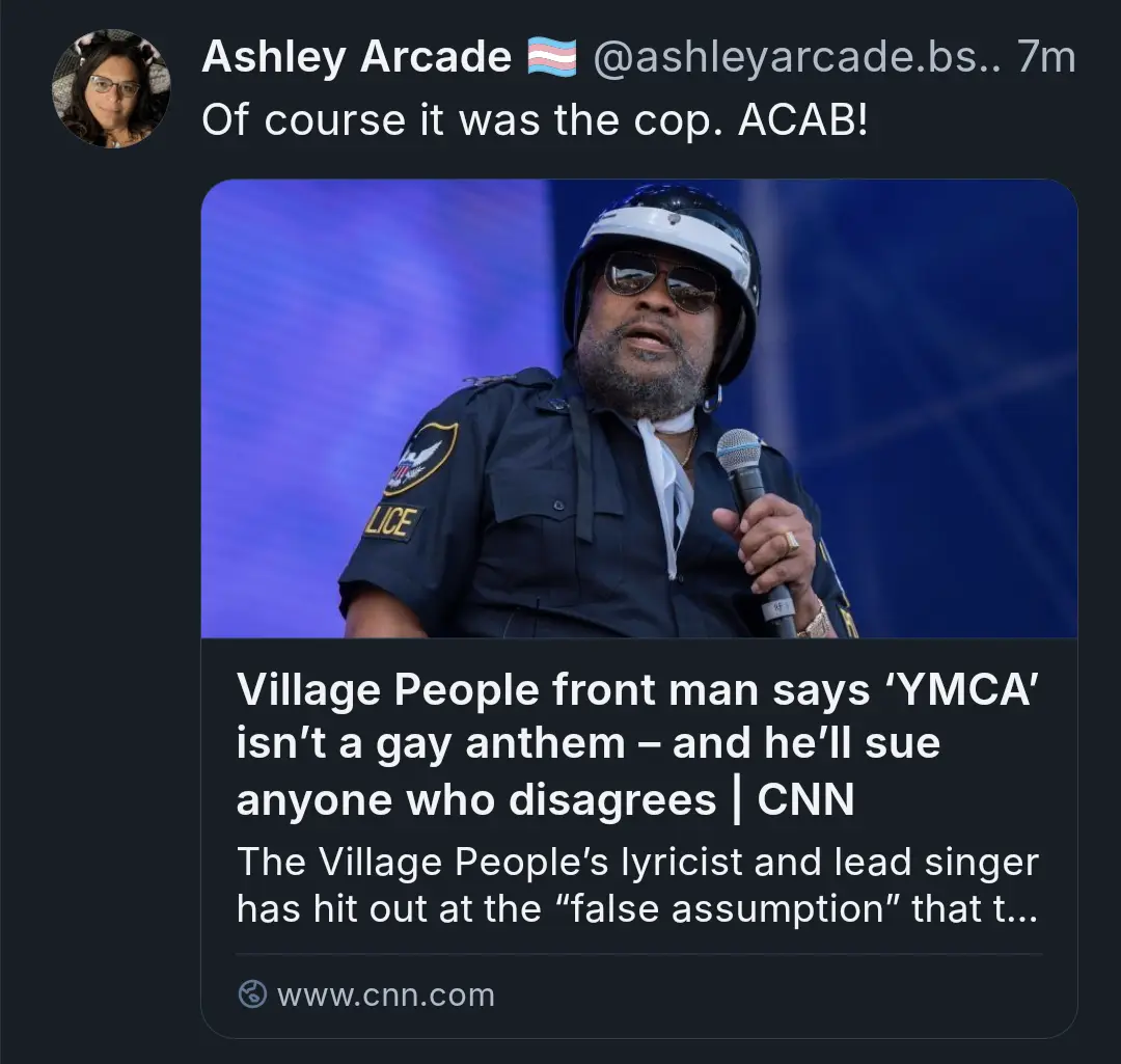 A screenshot of a tweet by Ashley Arcade showing a photo of Village People frontman Victor Willis in a police uniform…