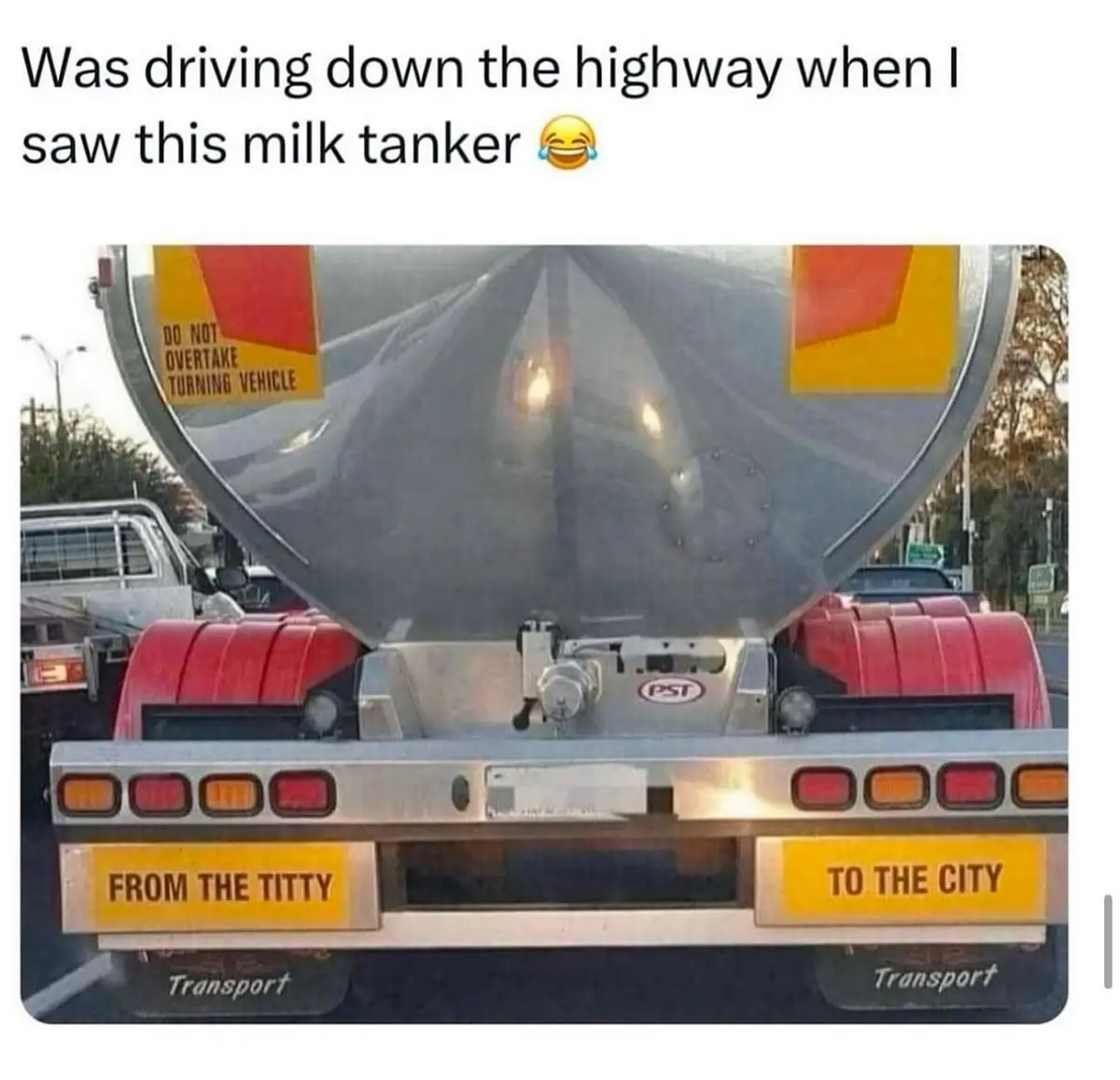 The image shows the rear of a large silver milk tanker truck with red fenders and a yellow warning sign that reads 'DO NOT…