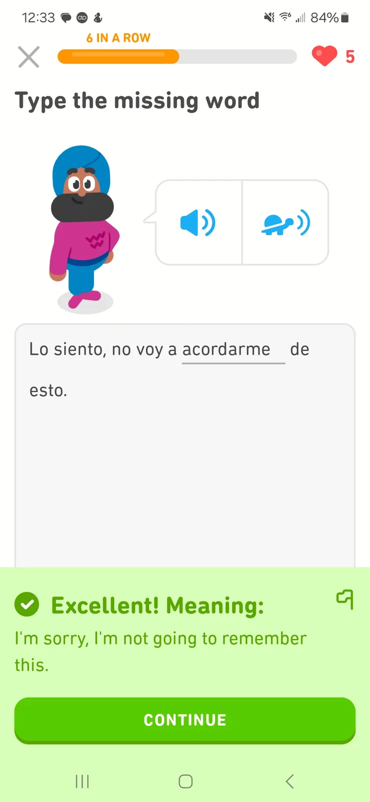 A language learning app screen shows a cartoon character with a blue turban and pink shirt. The prompt asks to type the…