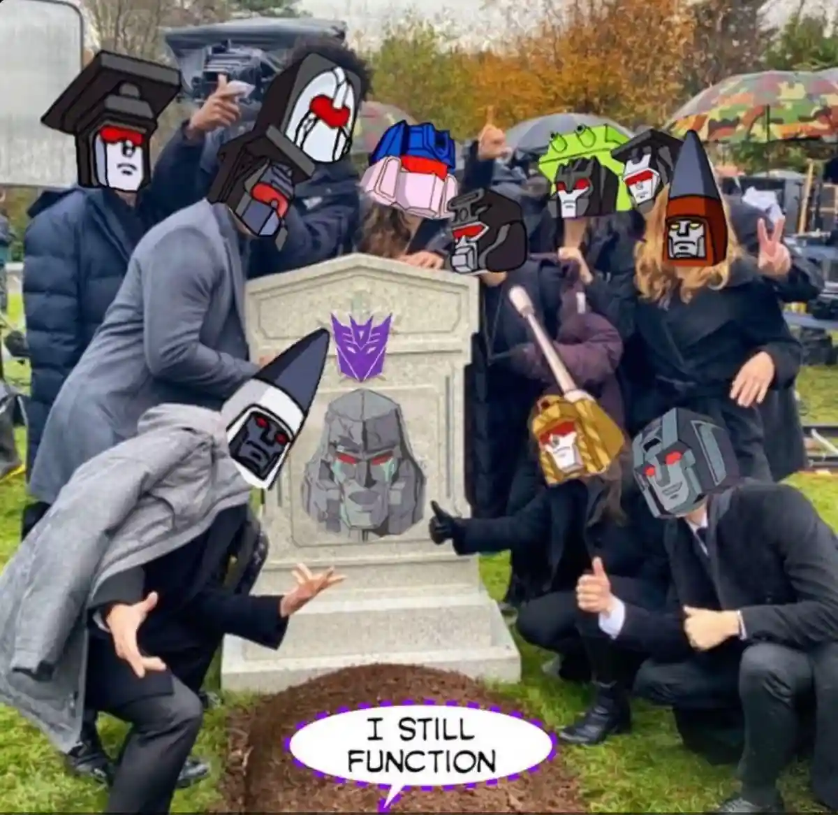 A group of people dressed in dark clothing, posing around a tombstone with a Transformers Decepticon symbol and a face…