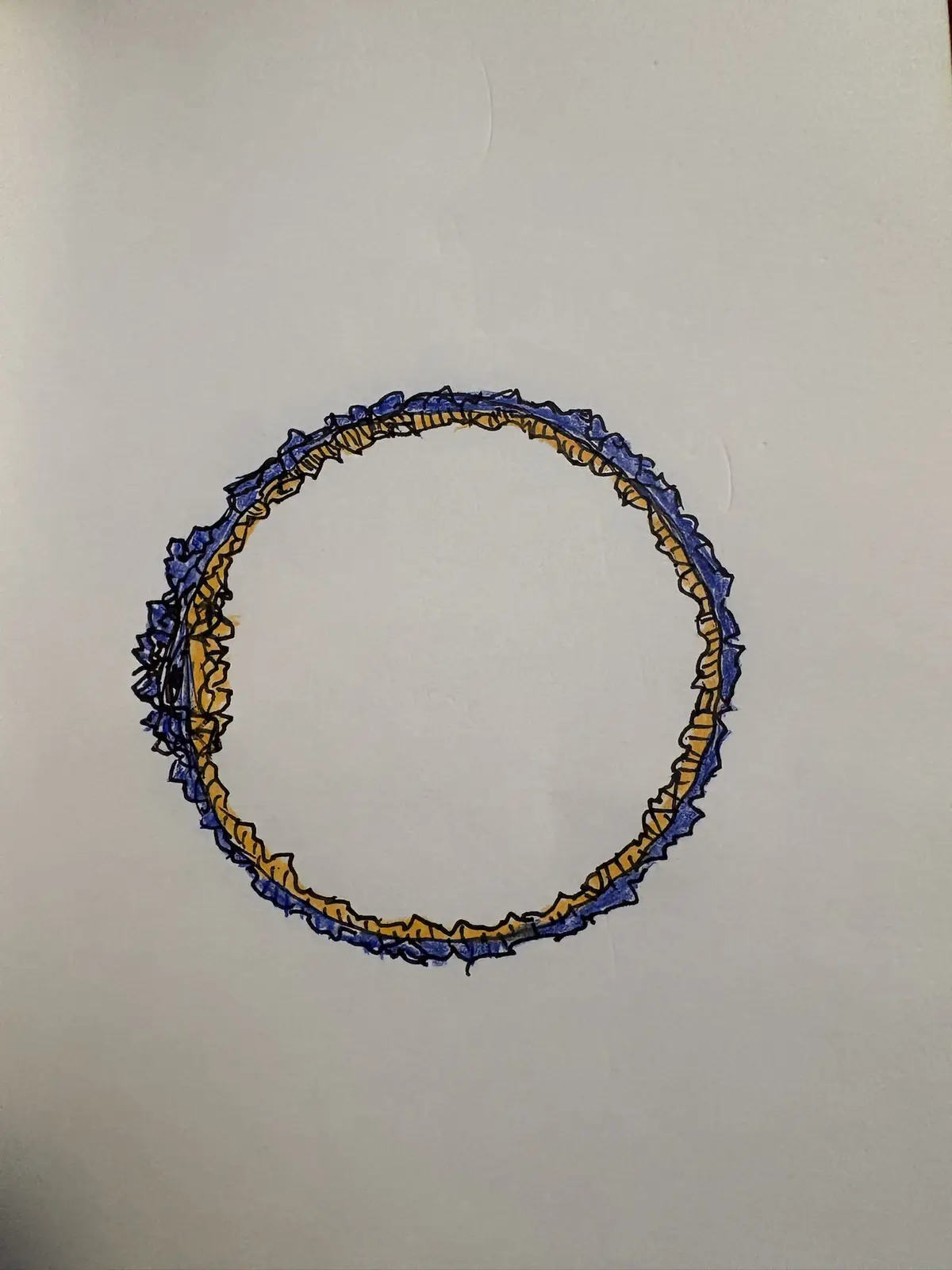 A hand-drawn circle on white paper, outlined with jagged blue and yellow lines resembling a crude, uneven ring or crown…
