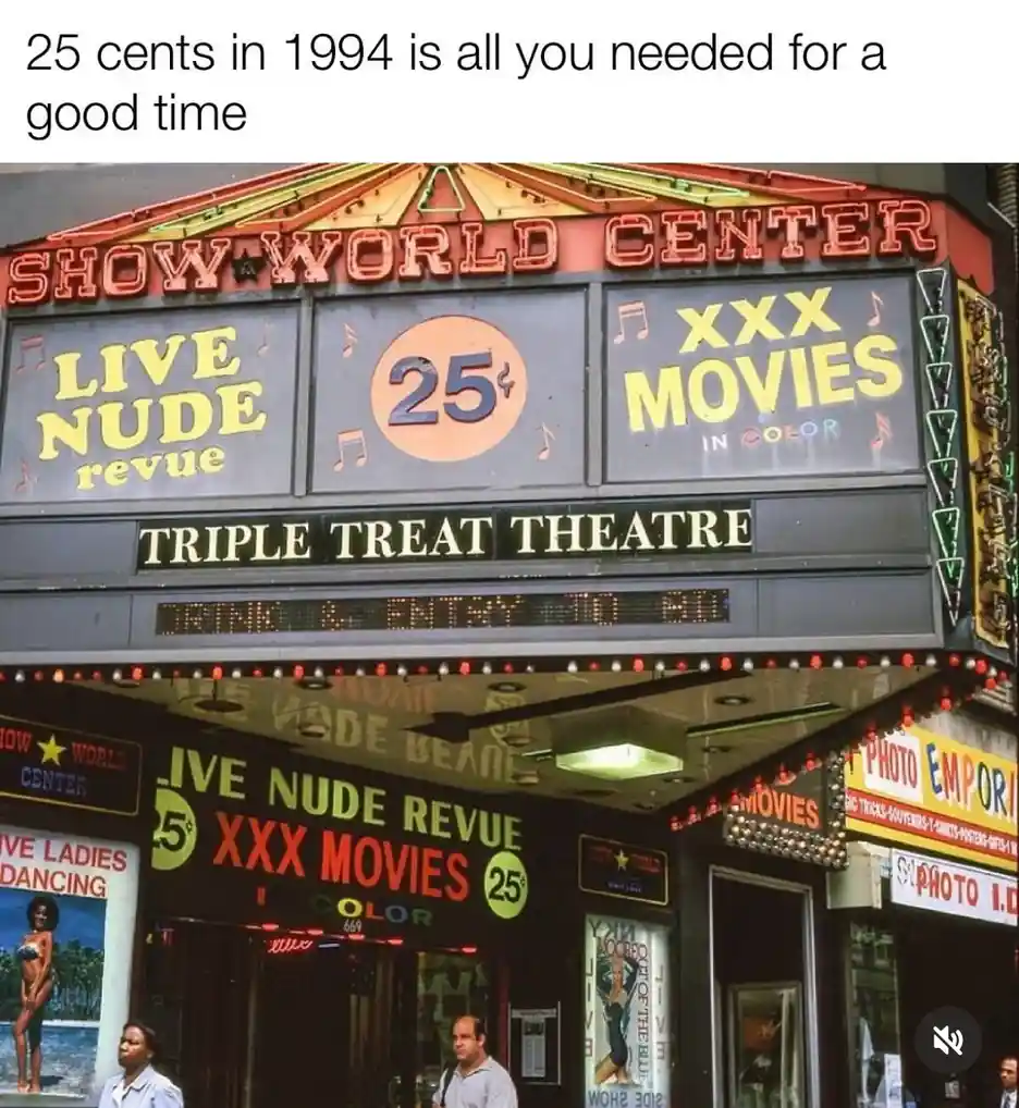 A vintage photo of the 'Show World Center' theater marquee advertising 'Live Nude Revue' and 'XXX Movies in Color' for 25…