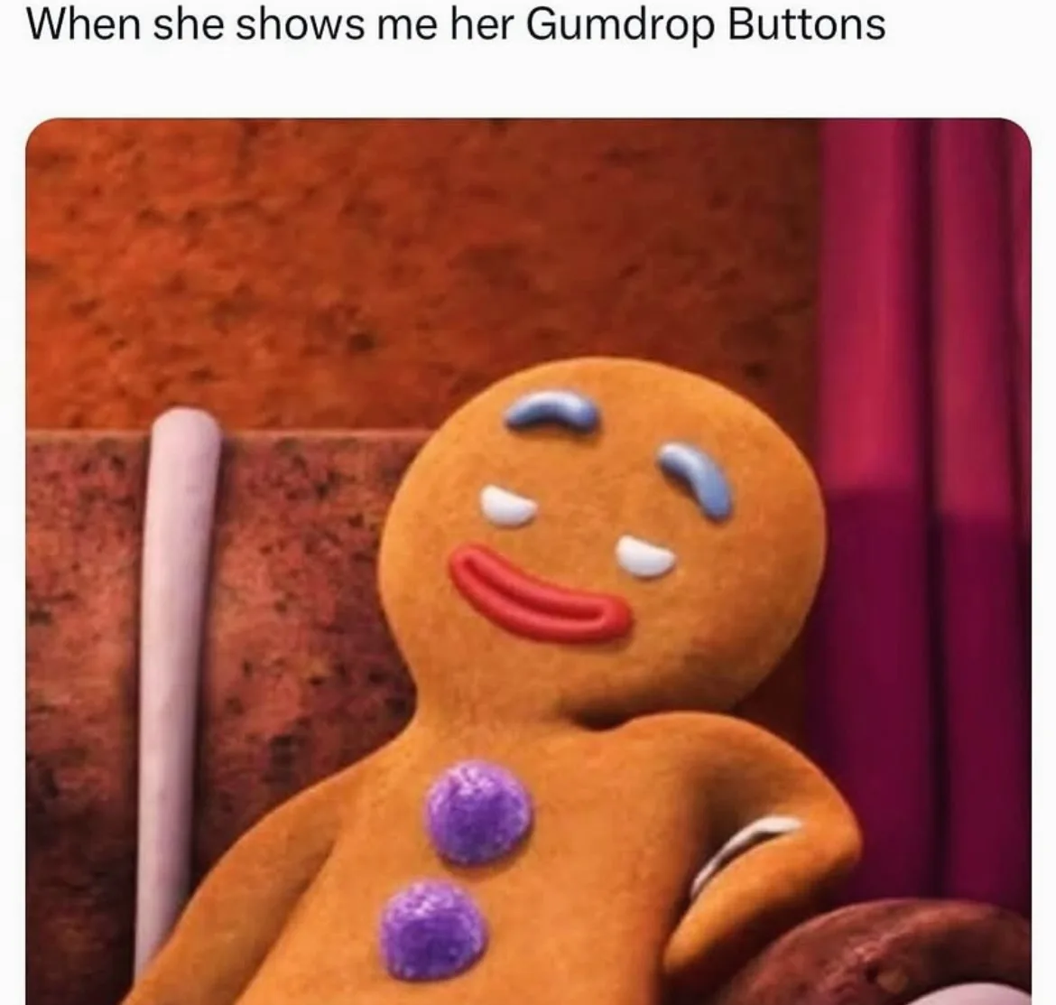 A close-up of a gingerbread man character with a smug, satisfied expression, featuring blue icing eyebrows, white icing…