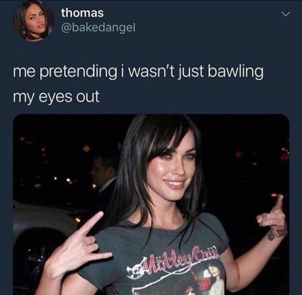 A screenshot of a tweet by user 'thomas' (@bakedangel) showing a photo of a woman with dark hair smiling and making rock…