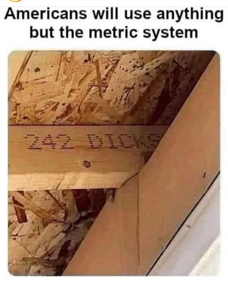 A close-up photo of a wooden beam in a construction setting, with the words '242 DICKS' visibly stenciled or carved into its…