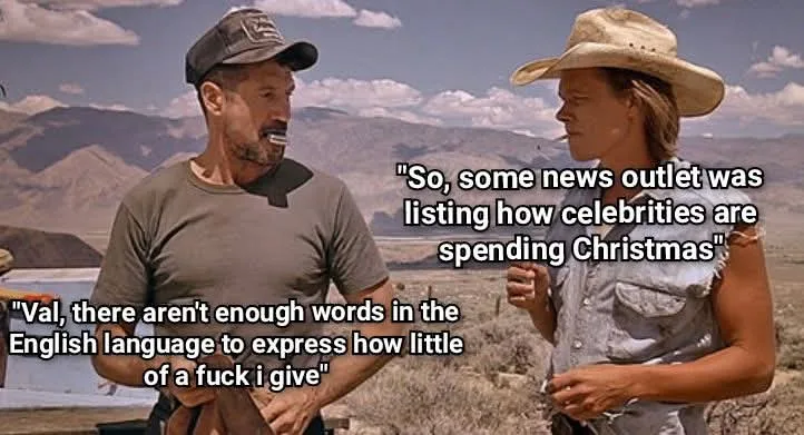 A still from the movie 'The Postman' shows two characters in a desert landscape. The man on the left, wearing a cap, has a…