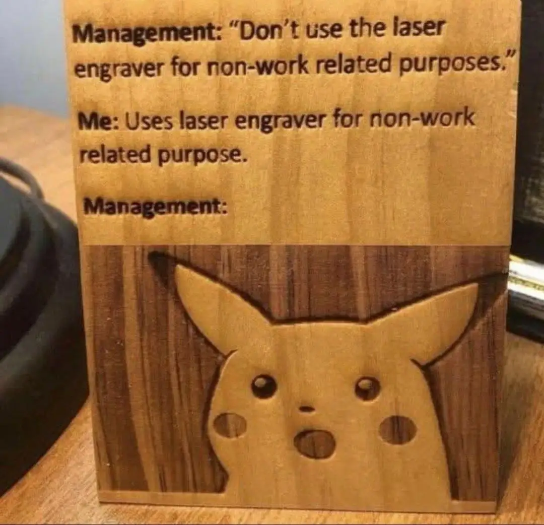 A wooden block with a laser-engraved Pikachu face at the bottom, looking surprised. The top half of the block has text…