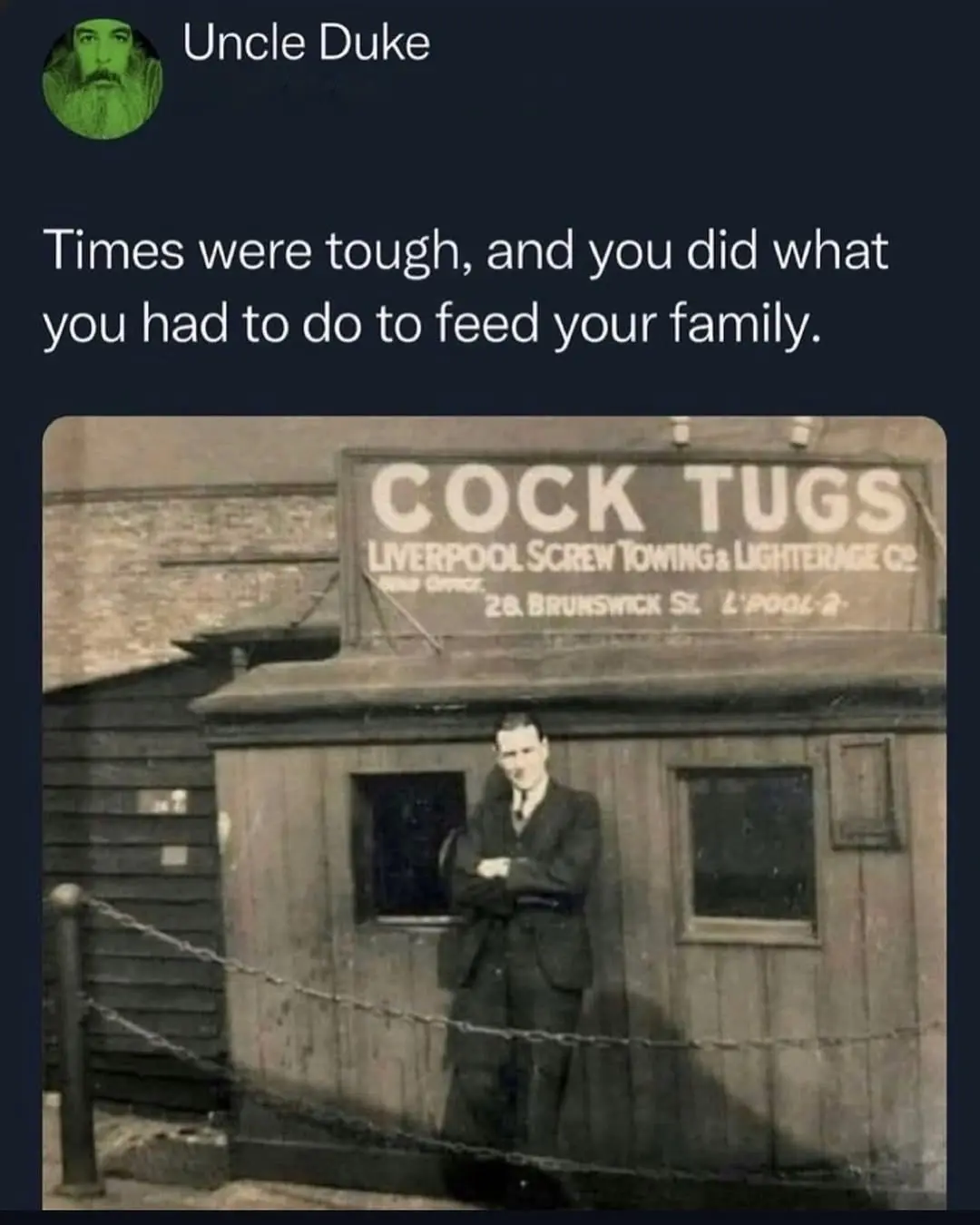 A sepia-toned historical photo shows a man in a suit standing confidently with arms crossed in front of a wooden building…