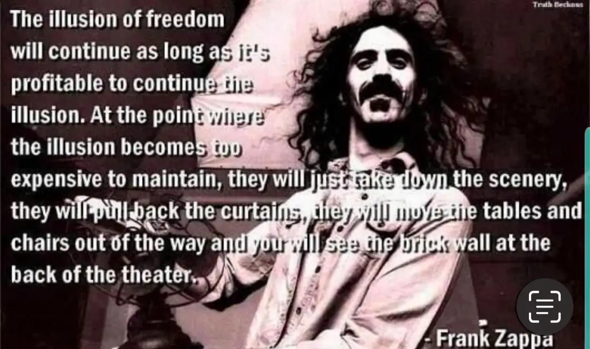 A black-and-white photo of Frank Zappa with long curly hair and a mustache, looking upward while seated. Large white text…