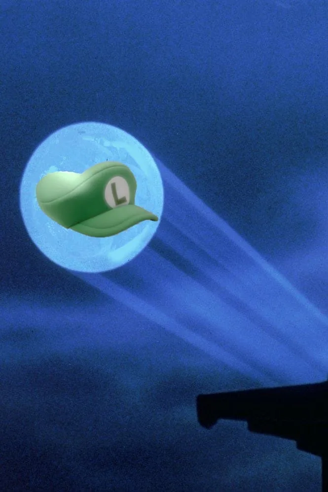 A green Luigi cap with a white 'L' logo is superimposed over a large, glowing blue moon in a dark night sky. Below, the…