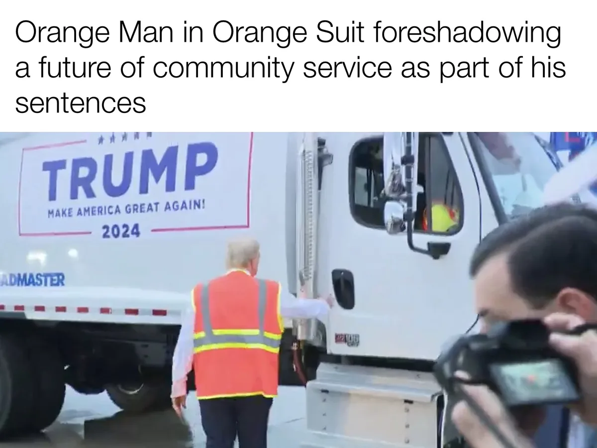 A man with blonde hair, seen from behind, wears a bright orange safety vest over a white shirt and stands next to a white…