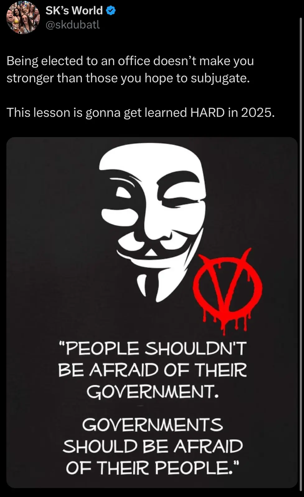 The image displays a black background with a white Guy Fawkes mask and a red anarchy symbol. Below, white text quotes…