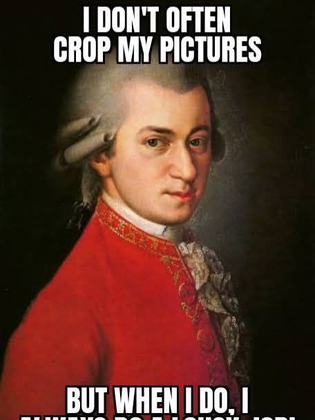 A cropped portrait of a man in historical attire, wearing a red coat with gold trim and a powdered wig, looking directly at…