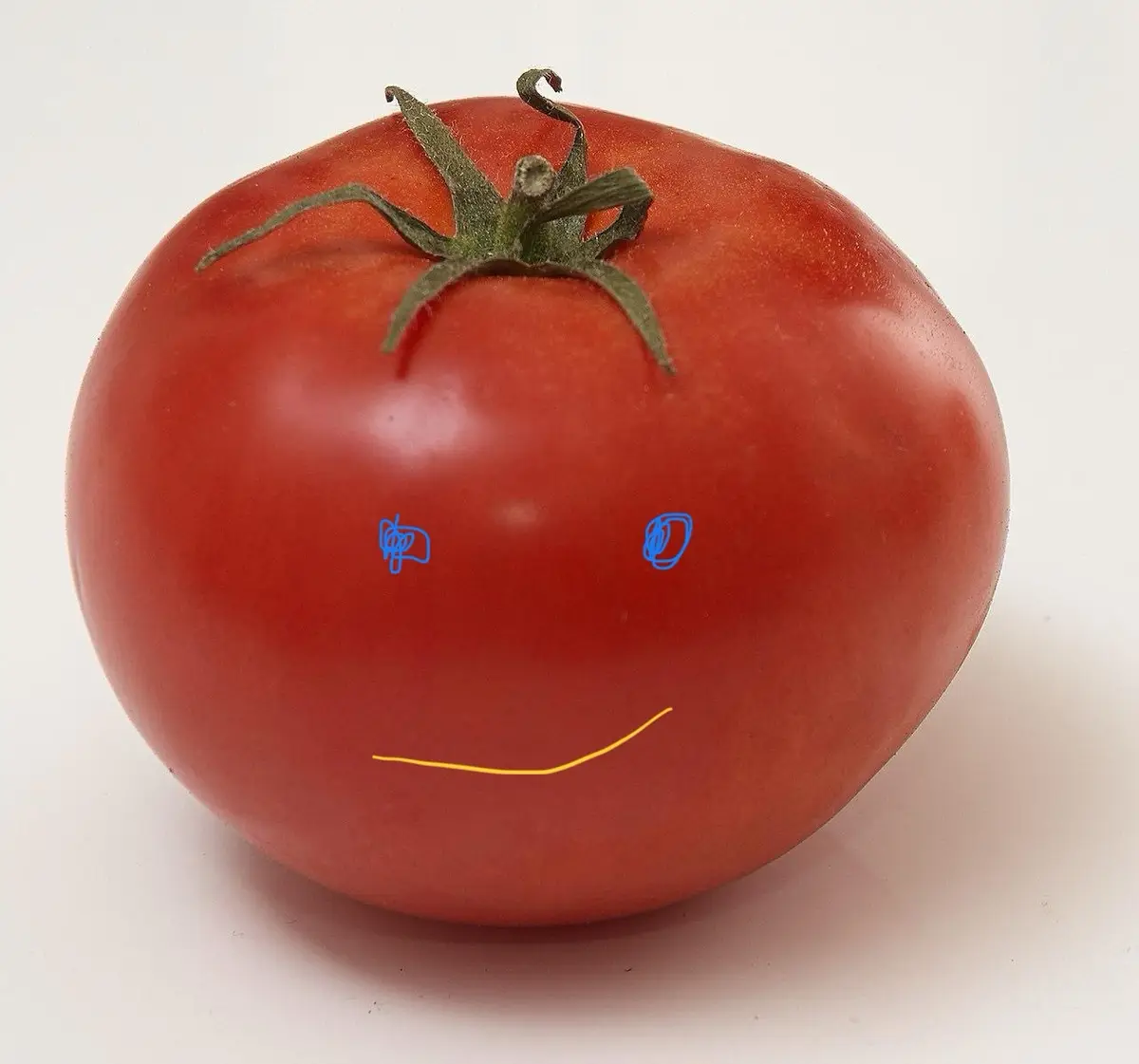 A red tomato with a green stem is photographed against a white background. Two blue scribbles serve as eyes and a yellow…