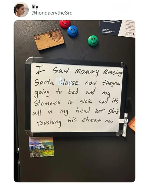 A whiteboard magnet on a black refrigerator displays handwritten text that reads 'I Saw Mommy kissing Santa clause now…
