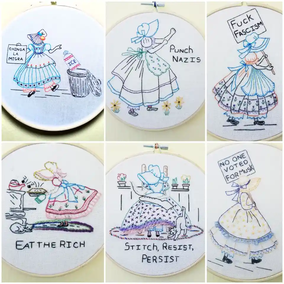 Six embroidered hoop art pieces depict a woman in a traditional dress holding signs with politically charged messages like…