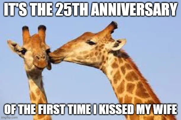Two giraffes are shown nuzzling or kissing each other against a clear blue sky. Large white text with a black outline is…