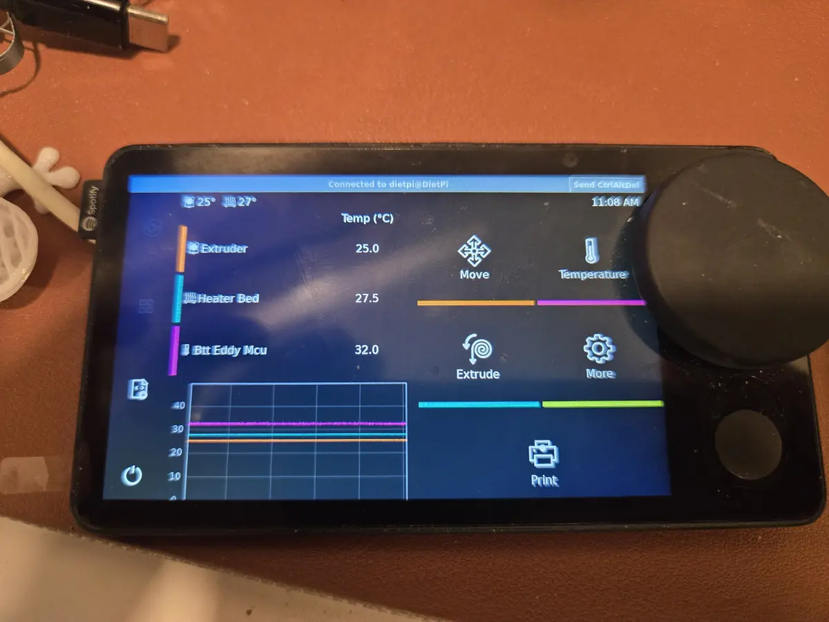 A tablet displaying a 3D printer control interface with temperature readings for Extruder (25.0°C), Heater Bed (27.5°C), and…
