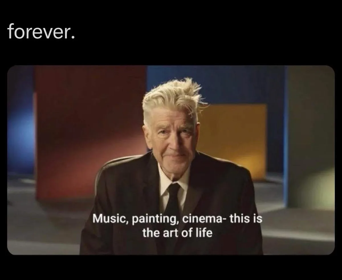 An older man with white hair, wearing a black suit and tie, sits in a chair against a colorful abstract background. The text…