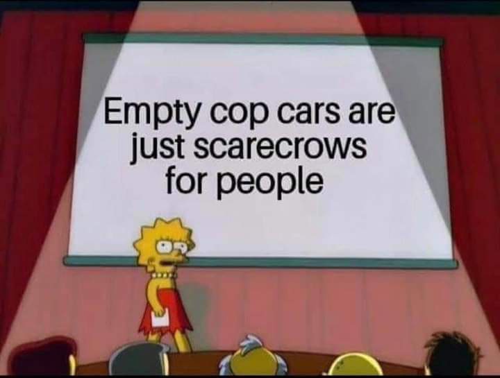A still from The Simpsons shows Lisa Simpson standing at a podium in front of a projection screen displaying the text 'Empty…