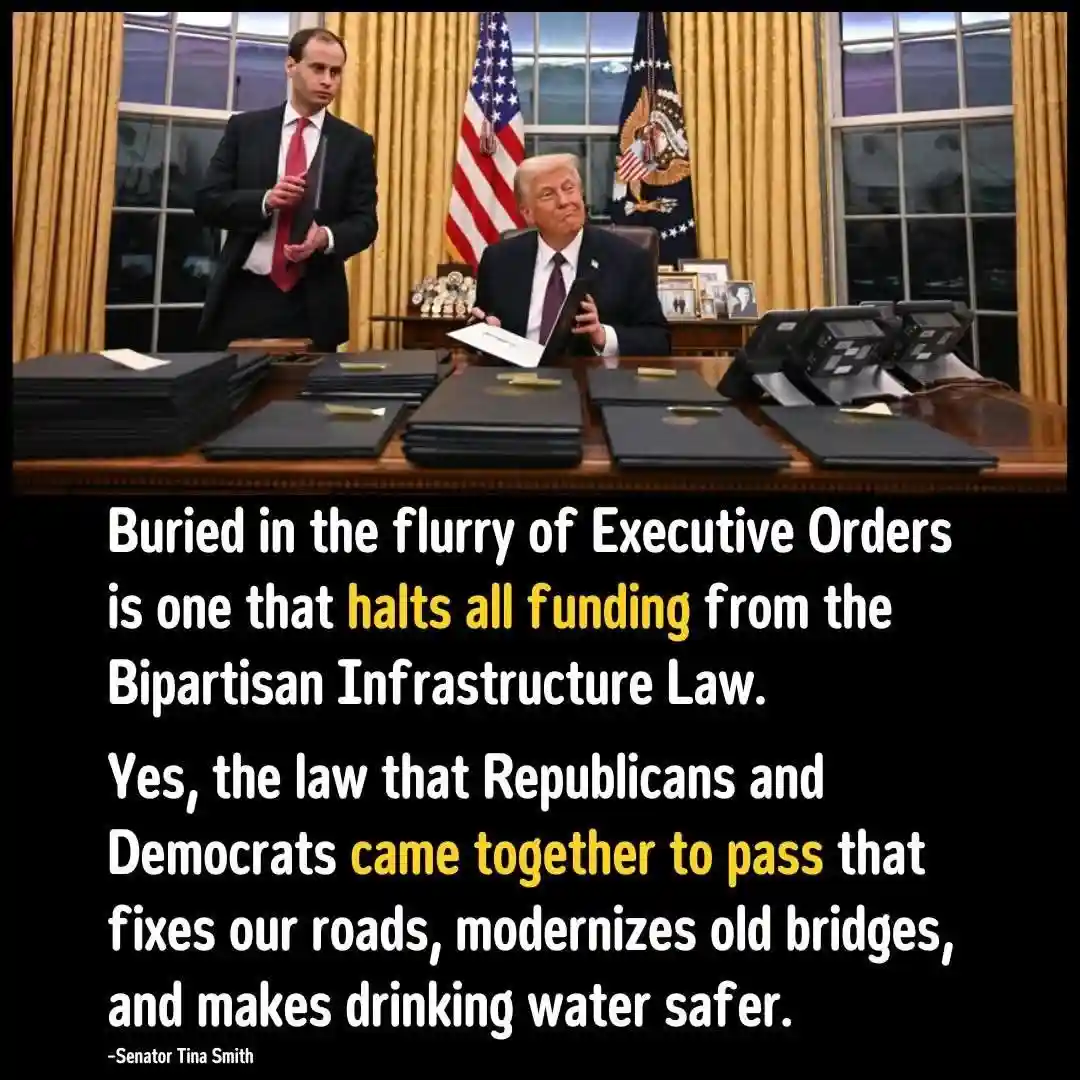 The image shows Donald Trump seated at a large wooden desk in the Oval Office, holding a tablet, with a man in a suit…