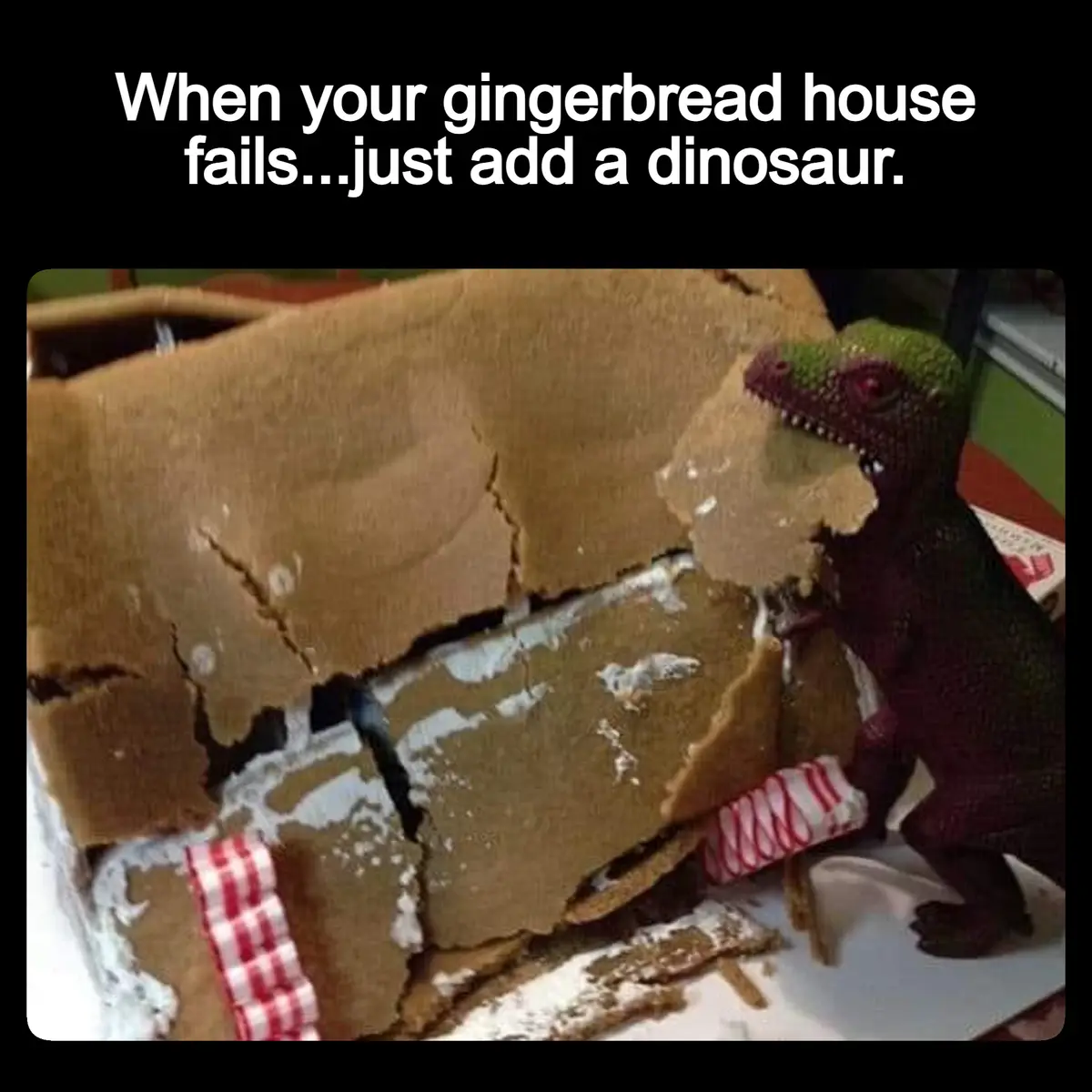 A close-up photo shows a partially collapsed gingerbread house with broken walls and white icing, next to a small purple…