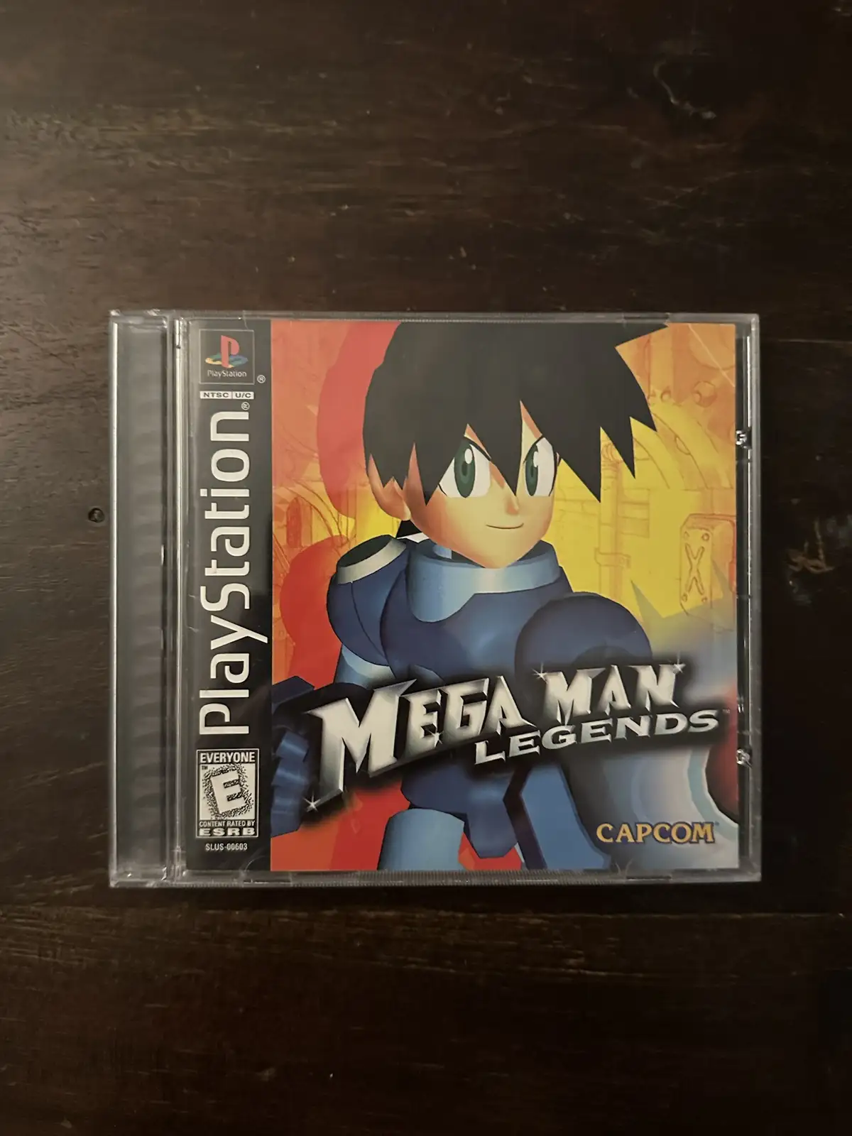 A physical PlayStation 1 game case for 'Mega Man Legends' by Capcom, featuring the game's protagonist in blue armor on the…
