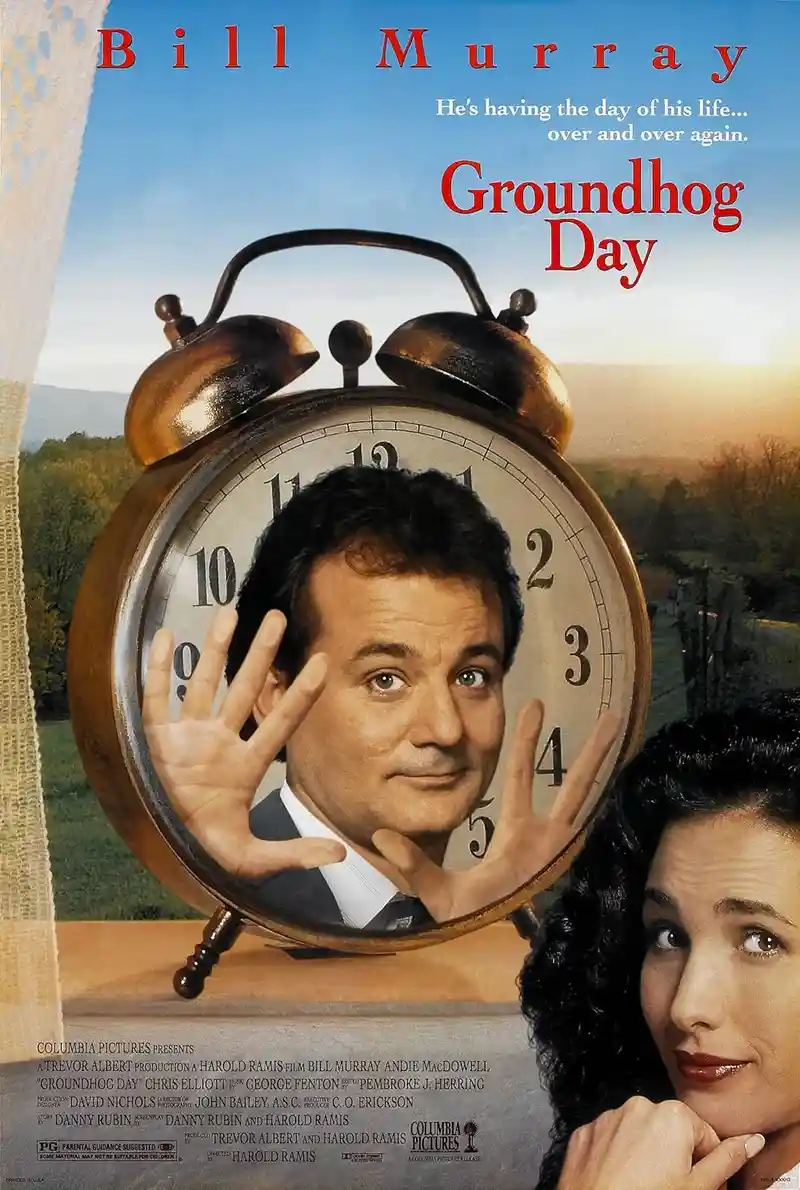 This is the official movie poster for 'Groundhog Day,' featuring Bill Murray's face inside a large brass alarm clock, with…
