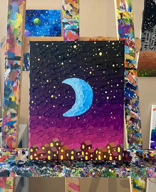 A textured, thickly painted canvas depicts a night scene with a blue crescent moon, yellow stars, and a gradient sky from…