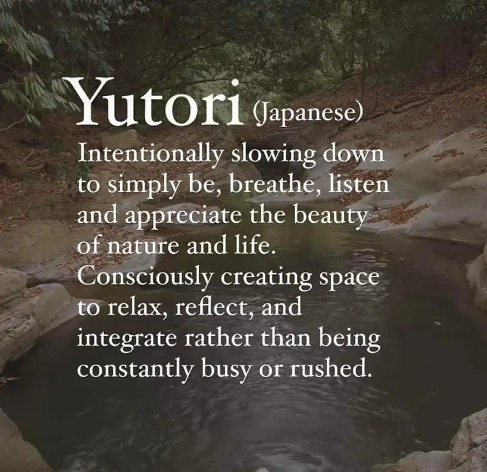 A serene forest stream flows between rocks under a canopy of trees, overlaid with white text defining 'Yutori' as a Japanese…