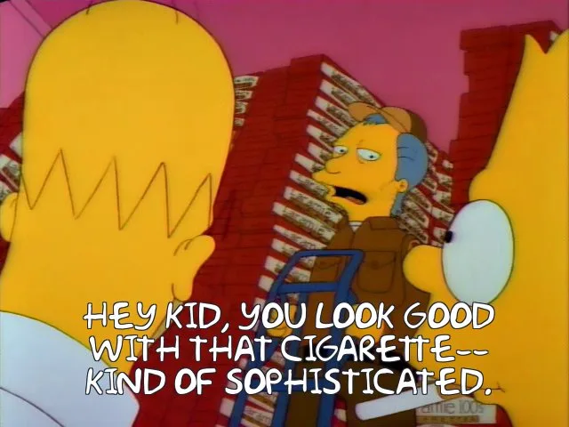 A still from The Simpsons shows a man in a brown jacket and cap standing between two yellow-skinned characters, one with a…
