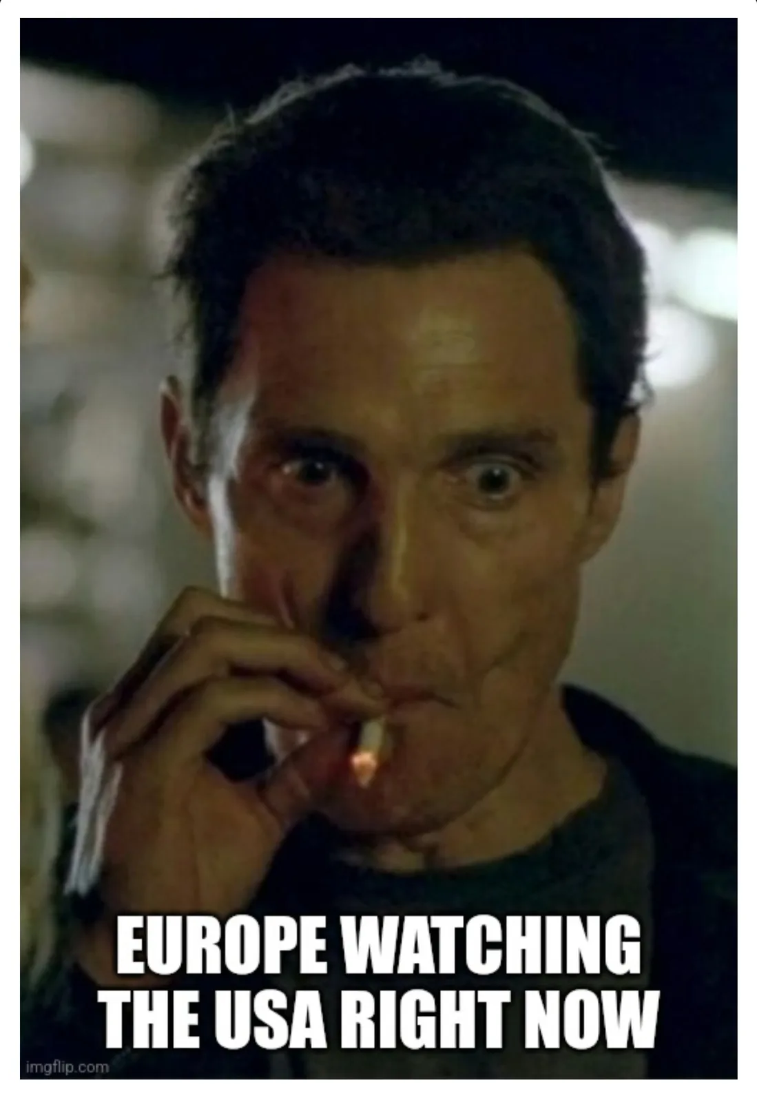 A man with wide, startled eyes holds a lit cigarette to his lips, looking directly at the viewer. The image has bold white…