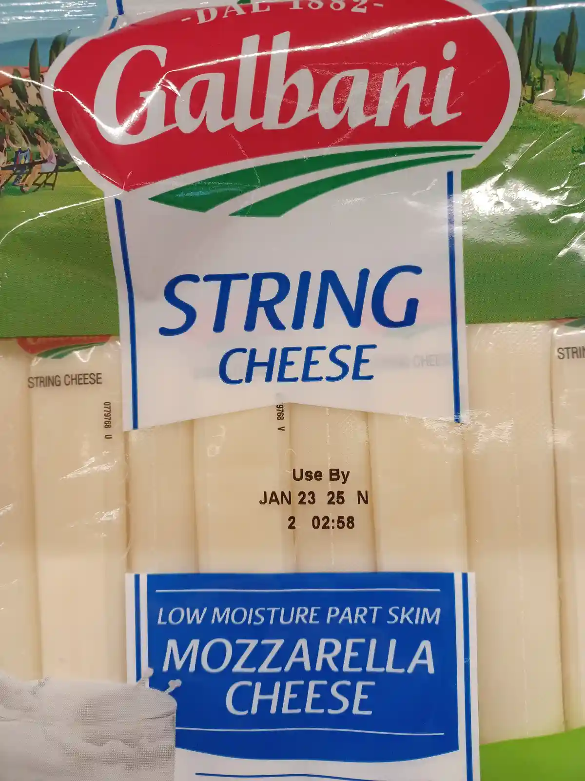 A close-up of a Galbani brand string cheese package, showing the product name and 'low moisture part skim mozzarella cheese'…