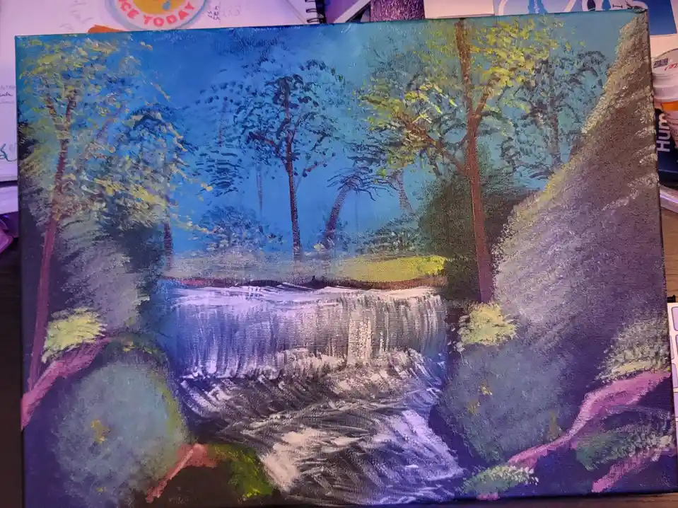 A hand-painted canvas depicts a stylized waterfall surrounded by trees under a blue sky, rendered with visible brushstrokes…