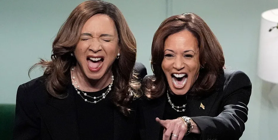 The image shows two identical-looking women side by side, both with brown hair and wearing black suits with pearl necklaces…